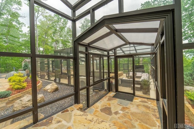 unfurnished sunroom featuring lofted ceiling