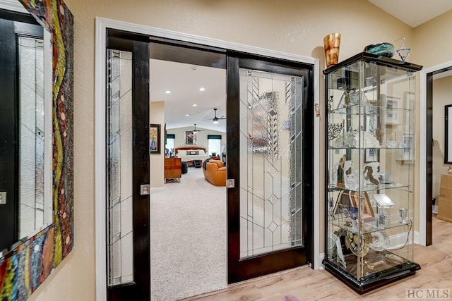 entryway featuring carpet floors and lofted ceiling