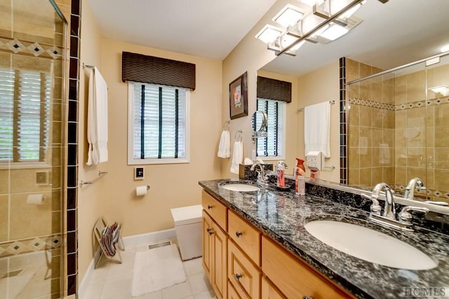 bathroom featuring vanity, a shower with door, and tile patterned floors