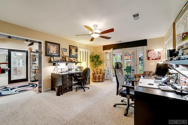 office area featuring light carpet and ceiling fan