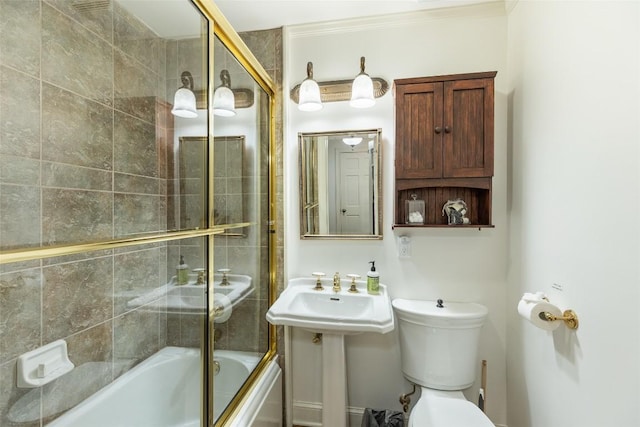 bathroom with shower / bath combination with glass door and toilet