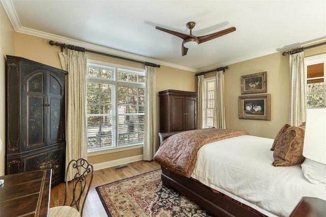 bedroom featuring crown molding, hardwood / wood-style floors, and ceiling fan