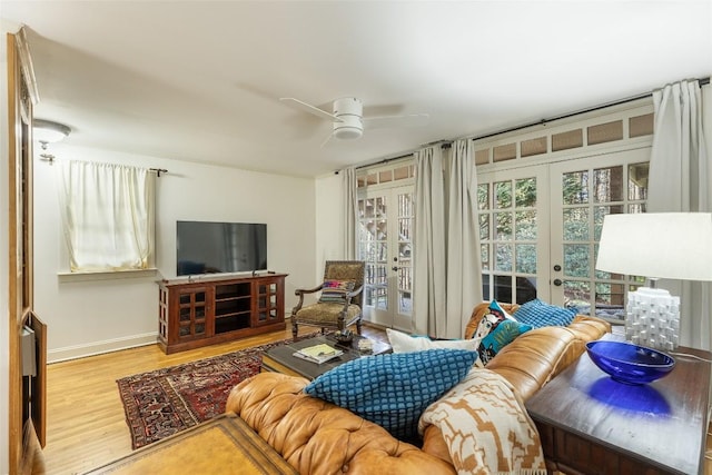 living room with french doors, ceiling fan, and light hardwood / wood-style floors