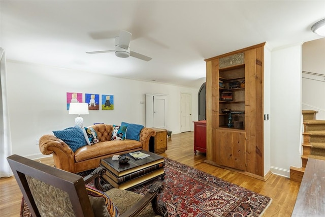 living room with light hardwood / wood-style floors and ceiling fan