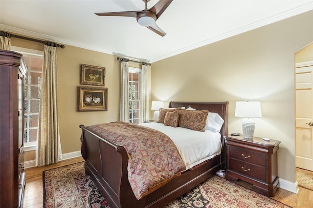 bedroom featuring wood-type flooring, ceiling fan, and crown molding