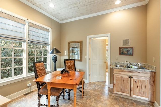 dining space with wood ceiling, ornamental molding, and sink