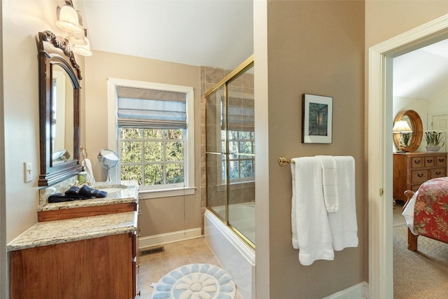 bathroom featuring vanity, vaulted ceiling, tile patterned floors, and shower / bath combination with glass door