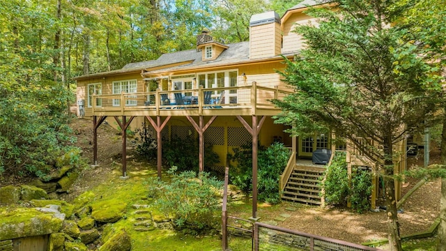 rear view of house featuring a deck