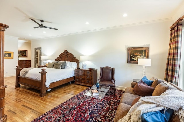 bedroom with hardwood / wood-style floors, crown molding, and ceiling fan