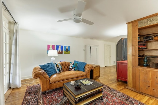 living room featuring light hardwood / wood-style floors and ceiling fan