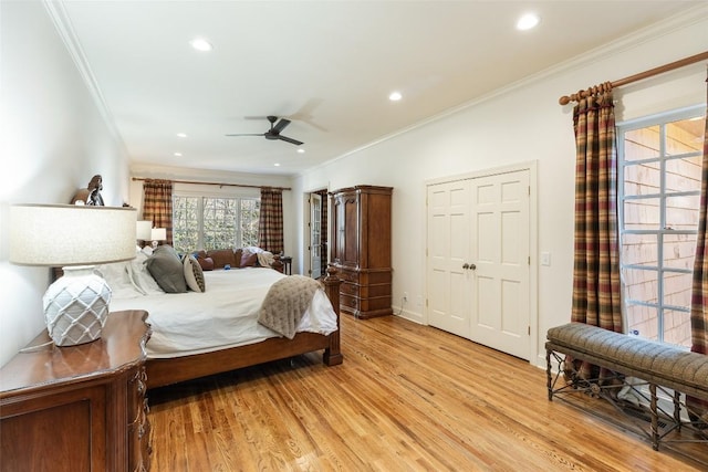 bedroom with crown molding, ceiling fan, and light hardwood / wood-style floors