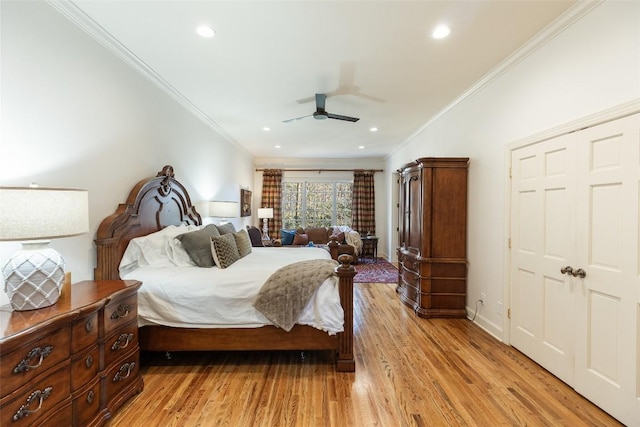 bedroom featuring crown molding, ceiling fan, a closet, and light hardwood / wood-style flooring