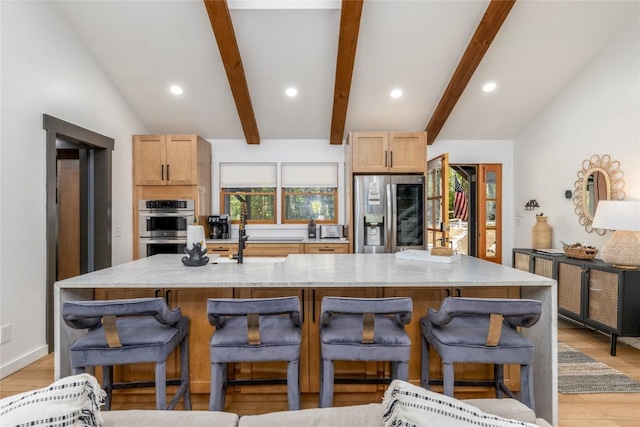 79 Azalea Ct, Sapphire, NC 28774 - kitchen with stainless steel appliances, light wood-type flooring, recessed lighting, a large island with sink, and a breakfast bar area