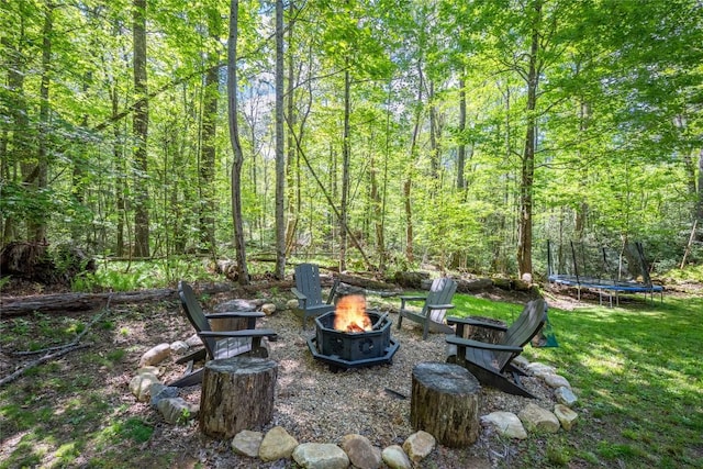 79 Azalea Ct, Sapphire, NC 28774 - view of green lawn with a fire pit, a trampoline, and a view of trees
