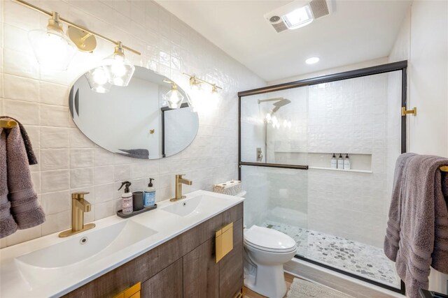 79 Azalea Ct, Sapphire, NC 28774 - full bath featuring tile walls, decorative backsplash, a stall shower, double vanity, and toilet