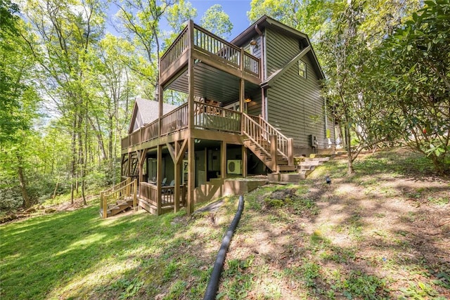 79 Azalea Ct, Sapphire, NC 28774 - rear view of house featuring stairway, a wooden deck, and a yard