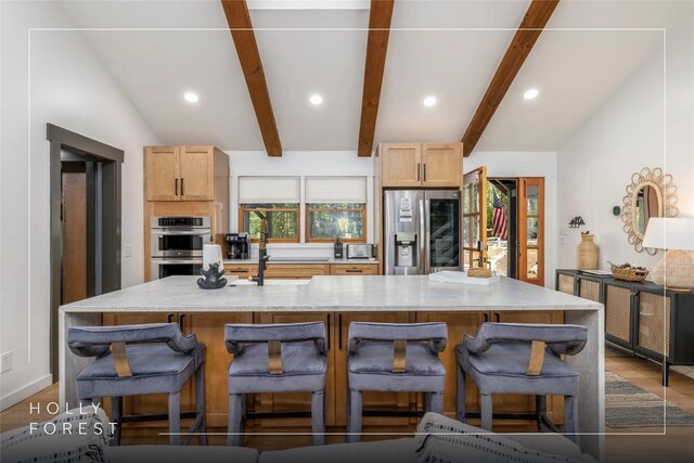 79 Azalea Ct, Sapphire, NC 28774 - kitchen featuring appliances with stainless steel finishes, light wood-style flooring, recessed lighting, a spacious island, and a breakfast bar
