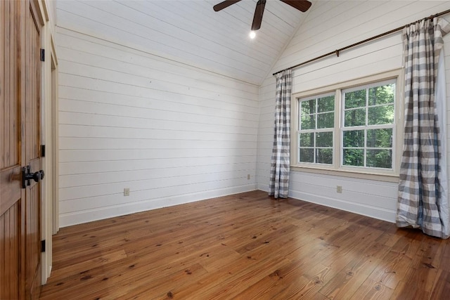 96 Mahalo Ln, Cullowhee, NC 28723 - unfurnished room featuring lofted ceiling, hardwood / wood-style floors, a ceiling fan, and wooden walls