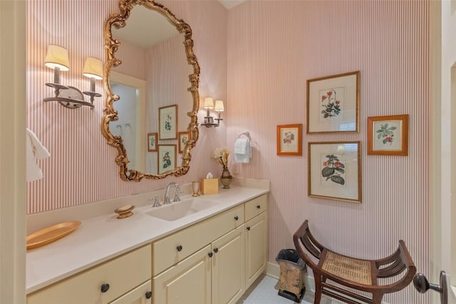 bathroom with wallpapered walls and vanity