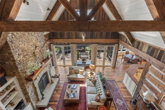 living room featuring french doors, beam ceiling, and hardwood / wood-style flooring
