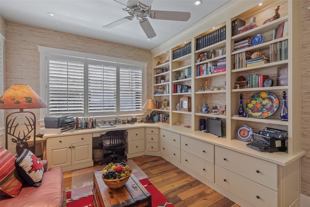 office area with a ceiling fan, recessed lighting, built in desk, and light wood-style floors