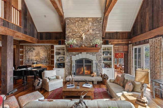 living area featuring high vaulted ceiling, beam ceiling, and wood finished floors