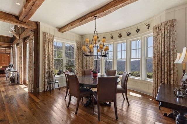 dining area featuring beamed ceiling, a chandelier, and dark wood-style floors