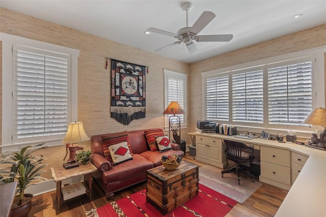office featuring built in study area, ceiling fan, wallpapered walls, recessed lighting, and light wood finished floors
