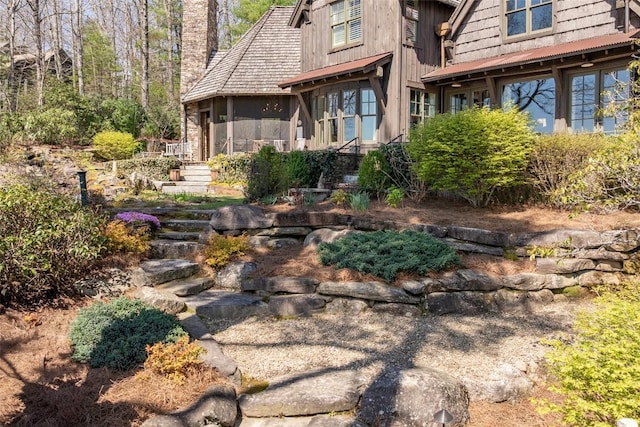 exterior space with a chimney and stairs