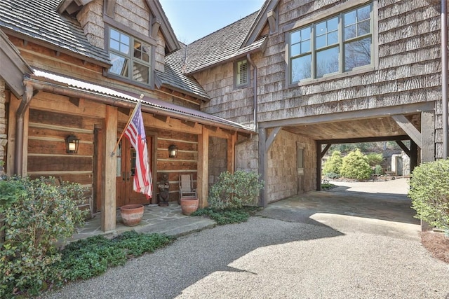 view of property exterior with driveway and a carport