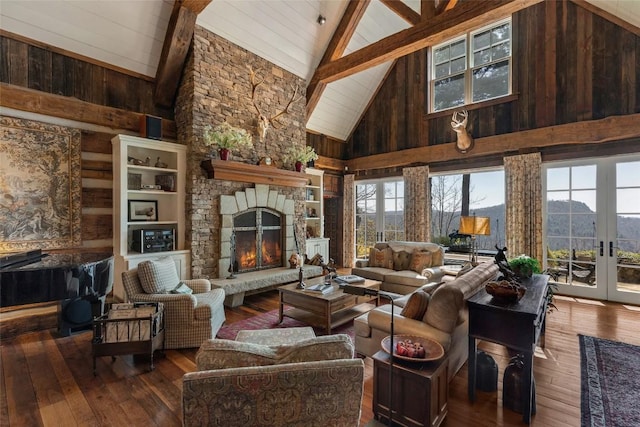 living room with wood-type flooring, wooden walls, high vaulted ceiling, and beamed ceiling