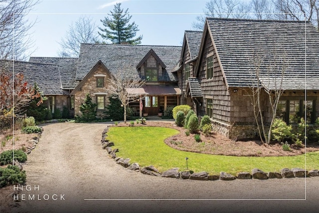 view of front of property with a front lawn and stone siding