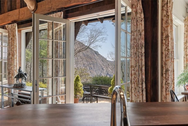 entryway featuring a healthy amount of sunlight, french doors, and a mountain view