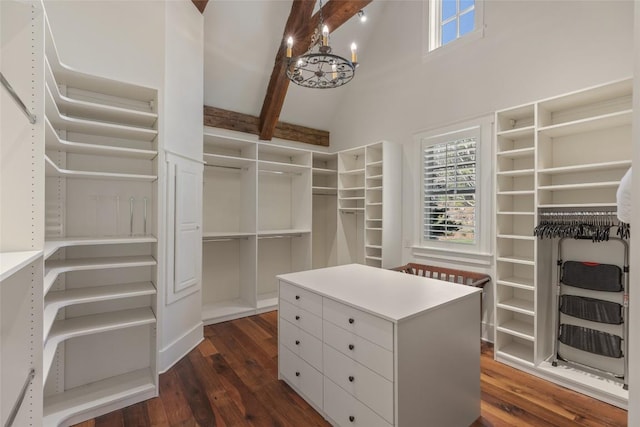 walk in closet featuring a notable chandelier, dark wood-style floors, high vaulted ceiling, and beamed ceiling