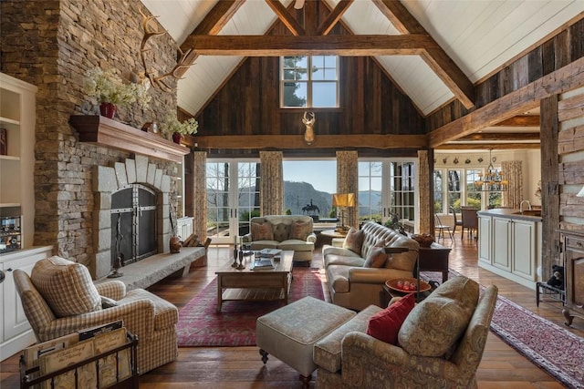 living room featuring plenty of natural light, a stone fireplace, hardwood / wood-style floors, and high vaulted ceiling
