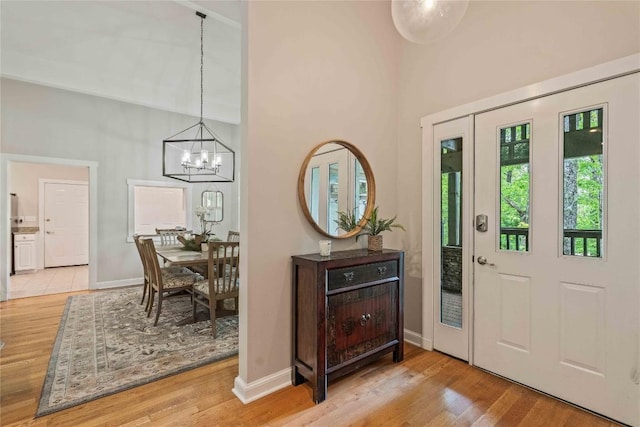 49 Jessamine Ln, Highlands, NC 28741 - foyer entrance featuring a chandelier, wood finished floors, a high ceiling, and baseboards