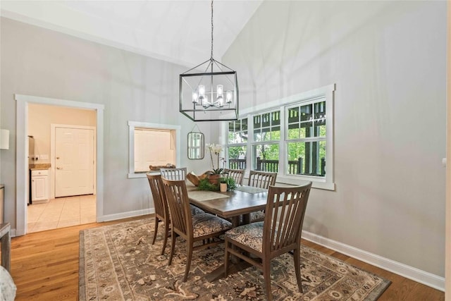 49 Jessamine Ln, Highlands, NC 28741 - dining area with a high ceiling, a chandelier, light wood-style flooring, and baseboards