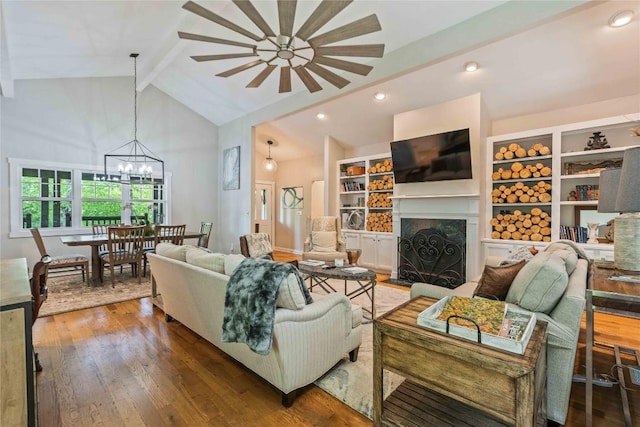 49 Jessamine Ln, Highlands, NC 28741 - living area with beam ceiling, a fireplace, wood-type flooring, a chandelier, and recessed lighting