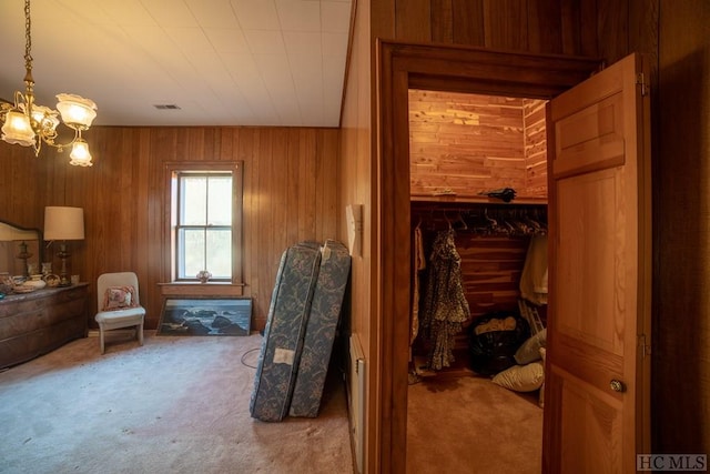 bathroom with an inviting chandelier and wood walls