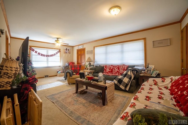 living room featuring crown molding, ceiling fan, and carpet floors