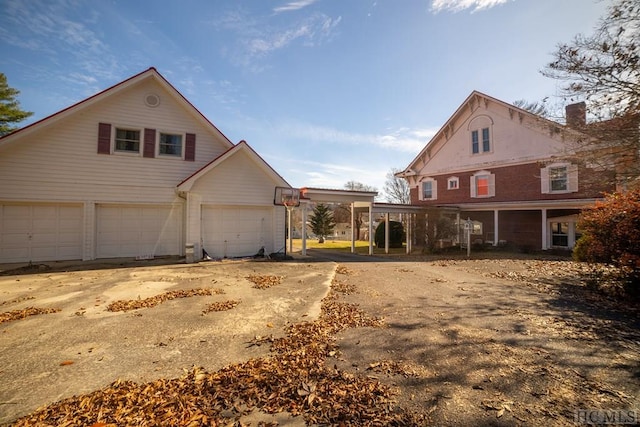 view of side of property featuring a carport and a garage