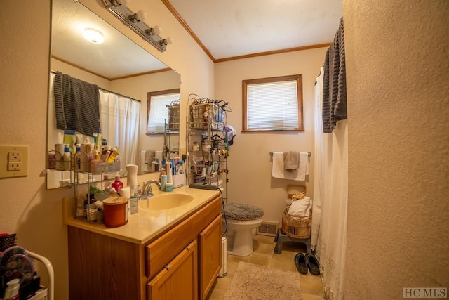 bathroom featuring vanity, crown molding, and toilet