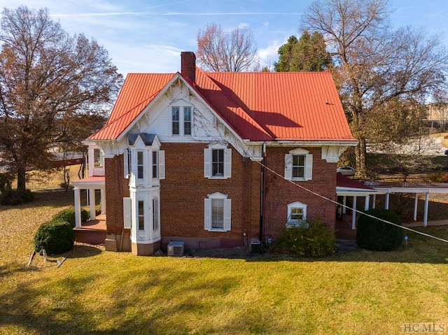 back of house featuring cooling unit and a lawn