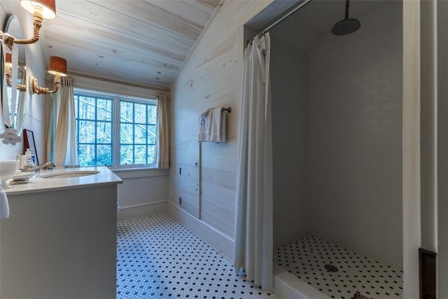 55 Oconee Belle Trl, Glenville, NC 28736 - bathroom with vaulted ceiling, vanity, tiled shower, and tile patterned floors
