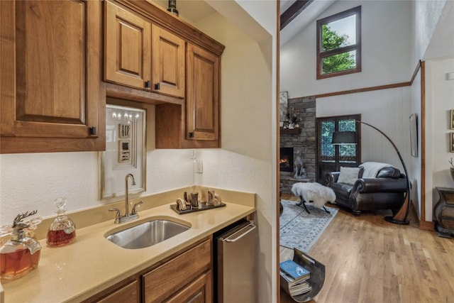 61 Carnoustie Dr, Sapphire, NC 28774 - kitchen featuring a sink, brown cabinets, light countertops, plenty of natural light, and a towering ceiling
