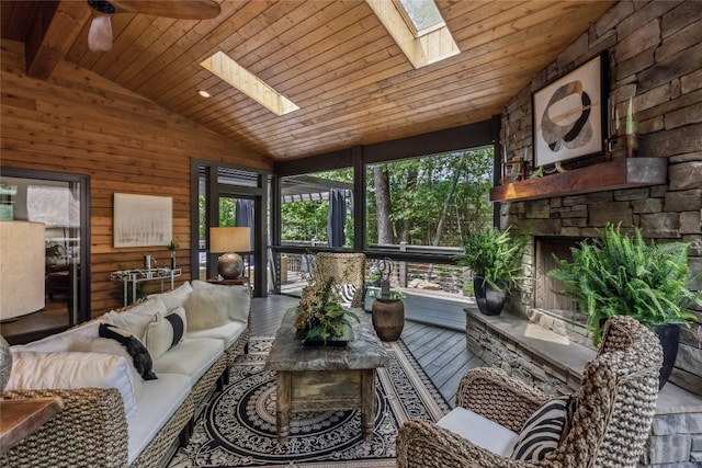 61 Carnoustie Dr, Sapphire, NC 28774 - sunroom with a skylight, lofted ceiling, healthy amount of natural light, a ceiling fan, and an outdoor living space with a fireplace