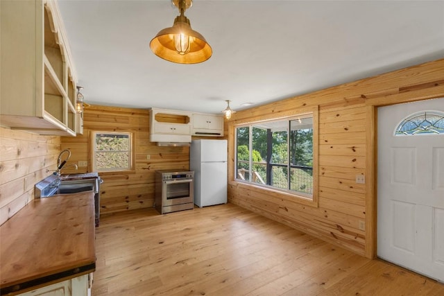 228 Mountain Laurel Dr, Franklin, NC 28734 - kitchen featuring range, freestanding refrigerator, wooden counters, wood walls, and healthy amount of natural light