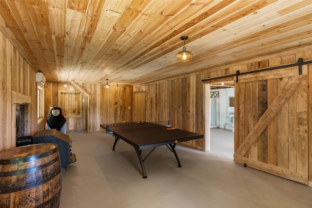 228 Mountain Laurel Dr, Franklin, NC 28734 - recreation room featuring wood ceiling, a barn door, wooden walls, and finished concrete floors