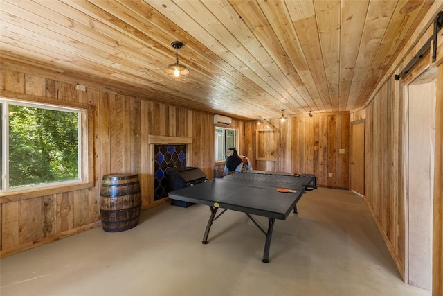 228 Mountain Laurel Dr, Franklin, NC 28734 - game room featuring wood ceiling, plenty of natural light, wooden walls, a wall mounted AC, and finished concrete floors