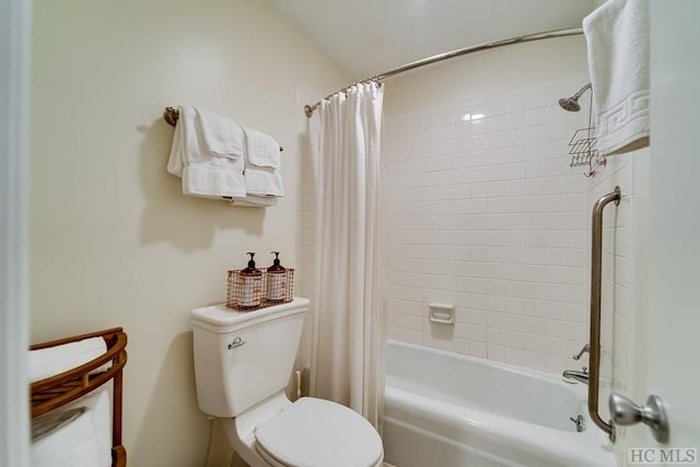 bathroom featuring shower / bathtub combination with curtain and toilet